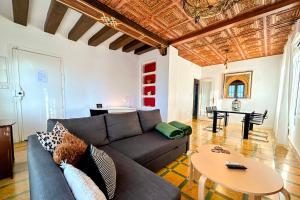 a living room with a couch and a table at Casa Rural con piscina privada y jardines - LA CASILLA in Cájar
