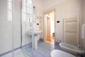 a white bathroom with a sink and a shower at Nel Cuore di Bologna V ,Bologna by Shortholidays in Bologna