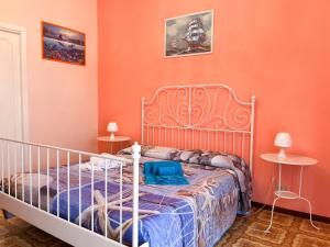 a bedroom with a bed with orange walls at Stella Marina in Giardini Naxos