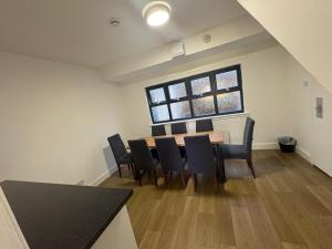 a room with a table and chairs and a window at Cunninghame 3 in Beith
