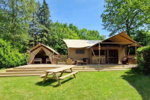 a yurt with a picnic table in the grass at Glamping Drouwenerzand in Drouwen
