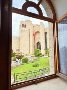 an open window with a view of a building at Vila Kalaja Kruje, Inside The Castle in Krujë
