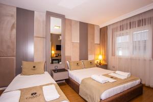 a hotel room with two beds and a window at Cadde 7 Otel in Bahçelievler