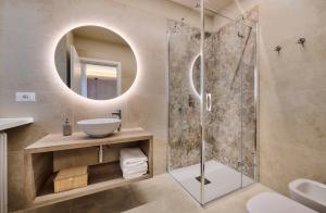 a bathroom with a shower with a sink and a mirror at Monolocale 3 - viale Turati, Lecco in Milan
