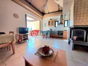 a living room with a table and a fireplace at Villa Lemóni - Villa by the sea with swimming pool and amazing view in Xiropigado