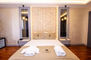 a bedroom with a bed with two towels on it at Cadde 7 Otel in Bahçelievler