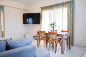 a living room with a table and chairs and a couch at Candia Relax House in Kandia