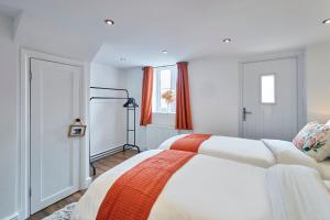 a bedroom with two white beds and a window at Host & Stay - Beagle Barn in Withington