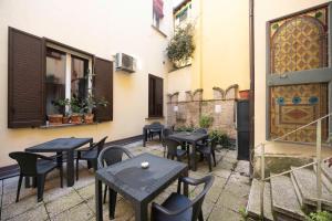 a patio with tables and chairs in a courtyard at Nel Cuore di Bologna V ,Bologna by Shortholidays in Bologna