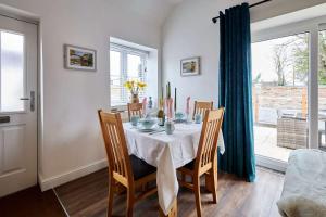 a dining room with a table and chairs and a window at Host & Stay - Beagle Barn in Withington +18 photos
