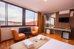 a hotel room with a bed and a large window at Cadde 7 Otel in Bahçelievler