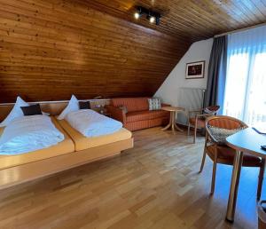 a bedroom with a bed and a couch and a table at Hotel-Restaurant Gasthof Adler in Neuenburg am Rhein +116 photos
