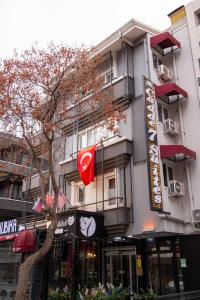 a building with a tree in front of it at Cadde 7 Otel in Bahçelievler +26 photos