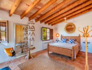 a bedroom with a bed and a wooden ceiling at Es Coco Mountain Cottage in Sóller by PriorityVillas in Port de Soller