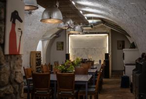 a dining room with tables and chairs and lights at TÉGED VÁRTALaK in Dörgicse
