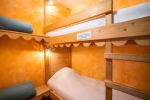 a small cabin with two bunk beds in it at Gîte Des Houx in Le Soulié