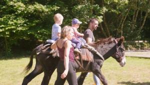 a group of people riding on a horse at Gite Fontaine in Le Soulié