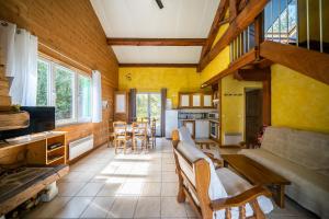 a living room with a couch and a kitchen at Gite Fontaine in Le Soulié