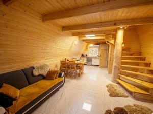 a large wooden room with a couch and a table at Bieszczadzki Reset A-Frame in Bukowiec