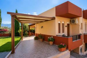 a view of a house with a patio at Argyroupolis Dimitris Rooms in Argyroupolis