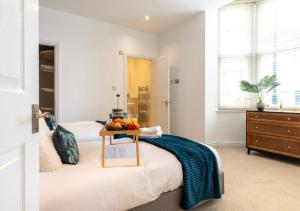 a bedroom with two beds and a table with fruit on it at Spacious 3 bed, Parking, Long stays welcome, Relocators, Families, Contractors in Knaresborough