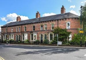 a large brick building on the corner of a street at Spacious 3 bed, Parking, Long stays welcome, Relocators, Families, Contractors in Knaresborough