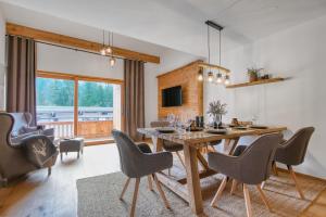 a dining room with a wooden table and chairs at Chalet Loferwinkl in Reit im Winkl