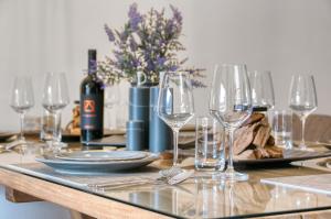 a table with wine glasses and a bottle of wine at Chalet Loferwinkl in Reit im Winkl