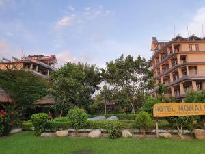 a hotel sign in front of a building at Hotel Monalisa Chitwan in Chitwan