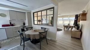 a kitchen and dining room with a table and chairs at LAS QUINTAS DE BRICIA 6-B in Posada de Llanes +11 photos