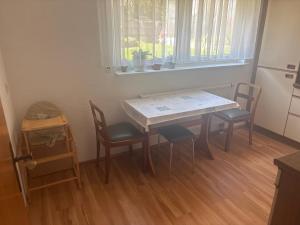 a table and chairs in a kitchen with a window at Ferienwohnung in Emmingen-Liptingen +3 photos