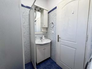 a white bathroom with a sink and a mirror at Candia Relax House in Kandia +67 photos