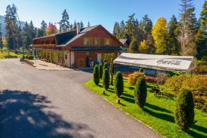 a building with a canopy on the side of a road at Hotel Polovnik in Belá