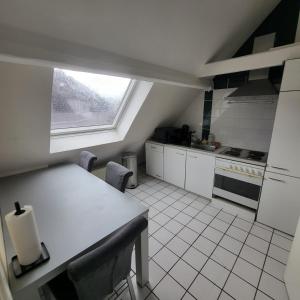 a kitchen with a counter and a window in it at Gemütliche Zimmer - Messe Gruga in Essen
