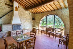 ein Esszimmer mit Tischen und Stühlen und einem großen Fenster in der Unterkunft La Fortezza Alta in Avigliano