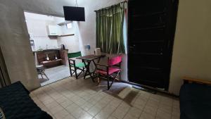 a room with a table and chairs and a kitchen at Departamento PB 2 Centro Pileta in Formosa