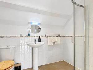 a white bathroom with a sink and a shower at The Stables Lydeard St Lawrence in Combe Florey +16 photos