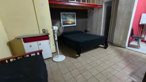 a room with a bed and a fan at Departamento PB 2 Centro Pileta in Formosa