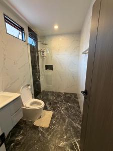 a bathroom with a toilet and a sink and a shower at Khaolak Beachhouse Kelolo in Khao Lak +26 photos