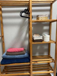a wooden shelving unit with towels and other items on it at Apartamento Império das Marés in Paracuru