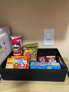 a black container filled with food and snacks on a table at Apartamento Império das Marés in Paracuru