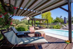 a patio with a swimming pool and a pergola at My Nest Accommodation in Privlaka