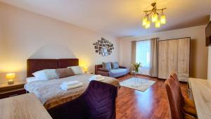 a bedroom with a large bed and a dining room at W Samiuśkim Centrum in Szczyrk