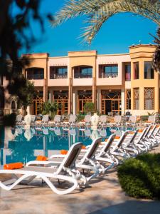 a row of lounge chairs in front of a hotel at Zalagh Kasbah Hotel & Spa in Marrakesh