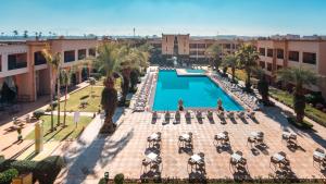 an overhead view of a pool with chairs and palm trees at Zalagh Kasbah Hotel & Spa in Marrakesh
