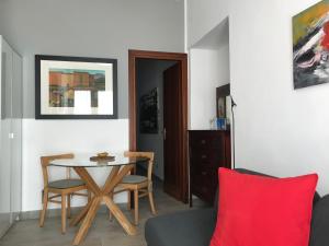 a living room with a table and a red pillow at Casitta in Mascali
