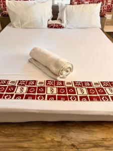 a rolled up towel sitting on a bed at Hide Away Villa in Watamu +49 photos