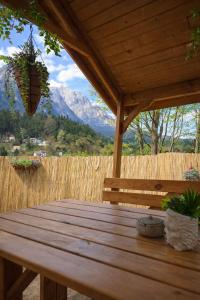 a wooden picnic table with a view of a mountain at UMANI Retreat 2 in Buşteni