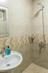 a bathroom with a sink and a shower at Strawberry in Borjomi +57 photos