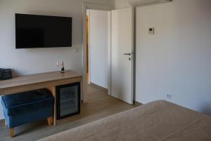 a bedroom with a bed and a tv on a wall at Šangulin Palace M in Biograd na Moru